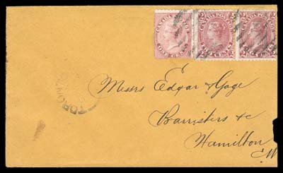 CANADA  1867 (September 11) Orange envelope bearing a scarcer franking consisting of a 1c rose single and 2c carmine red pair perf 12; 1c shows Major Misplaced Entry (Position 28) with various prominent marks throughout design and in lower right margin; cover slightly reduced at right but otherwise clean, stamps cancelled by light grids, large portion of Toronto split ring dispatch and mailed to Hamilton with clear next-day backstamp. Of the dozen such 5c frankings reported this example is particularly desirable with the seldom seen variety, F-VF (Unitrade 14xi, 20i) ex. Norman Brassler (October 1990; Lot 122)