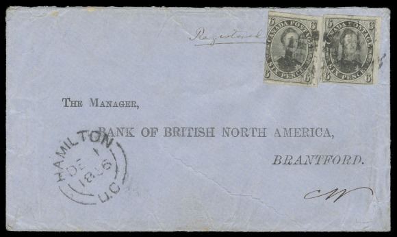 SIX PENCE AND TEN CENTS  1856 (December 1) Blue cover with pre-printed addressee "The Manager, Bank of British North America, Brantford." bearing an extremely rare domestic franking consisting of two examples of the 6p deep slate grey on wove paper, left stamp cut in at left side, otherwise both stamps with clear to very large margins; cancelled by an unusual very early usage of a segmented cork cancel, clear Hamilton double arc dispatch at left, manuscript "Registered" denoting the required 1 penny registry fee was prepaid in cash, light partial blue receiver backstamp. Minor cover wrinkling from heavy original content of the letter and portion of top backflap missing from red wax seal removal. A spectacular and immensely rare 13 pence registered quadruple domestic letter rate, F-VF (Unitrade 5)Provenance: Gerald Wellburn Canada Pence Issue Collection (private sale 1980s)Census: According to the Canada Pence Issue 1851-1859 Census compiled by Wayne Smith (as of January 2022), this is the only known domestic registered cover franked with two 6 pence stamps. There is a similarly franked cover recorded in the census, mailed domestically as a Money Letter (we have not seen it).