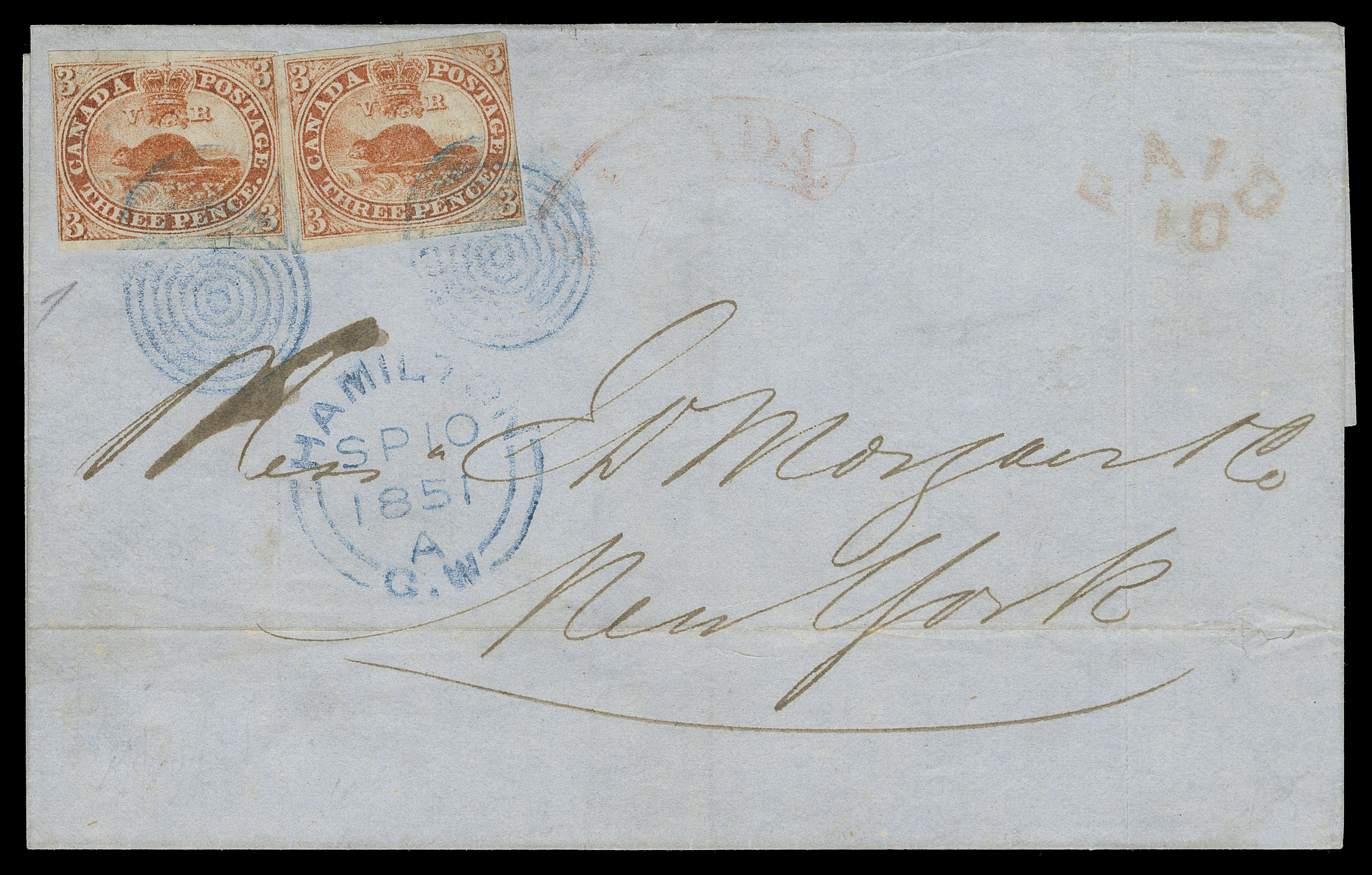 THREE PENCE AND FIVE CENTS  1851 (September 10) Blue folded cover from Hamilton to New York, bearing two singles of the 3p orange red shade on handmade laid paper with prominent laid lines, just clear to large margins, small sealed tear at upper left of left stamp, both tied by superb, visually striking concentric rings IN BLUE with same-ink Hamilton double arc dispatch, light arc CANADA and PAID / 10 border exchange handstamps in red. A very scarce usage of the 3p Beaver paying the 6p rate to the US, F-VF (Unitrade 1a)